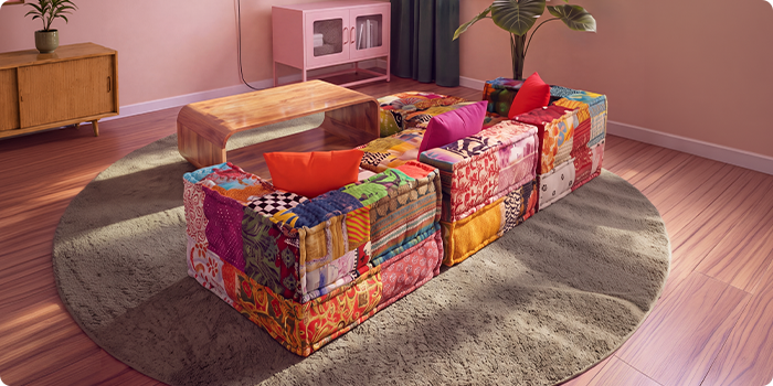 Kolorowa patchworkowa sofa modułowa ustawiona wokół drewnianego stolika kawowego na okrągłym dywanie w nowoczesnym salonie.